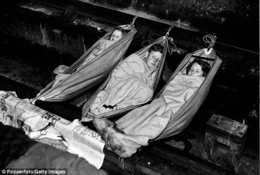 Three children sleeping in a London Underground shelter