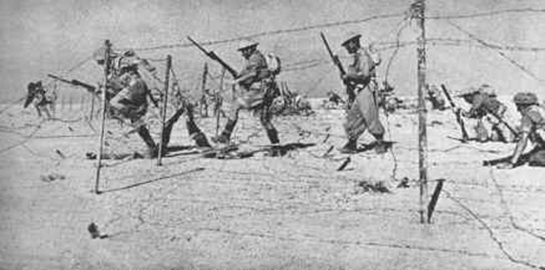 Troops negotiating barbed wire