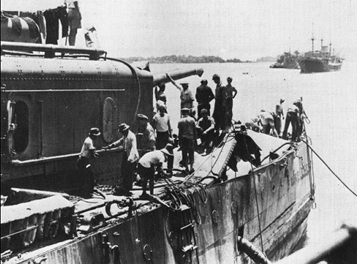 Crew Inspects Damage From Japanese Bombs