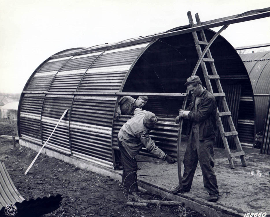 Men constructing a steel hut