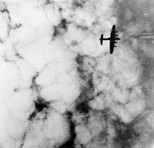 Lancaster silhouetted against smoke