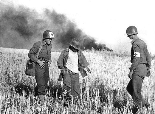 Medics assist an injured American soldier