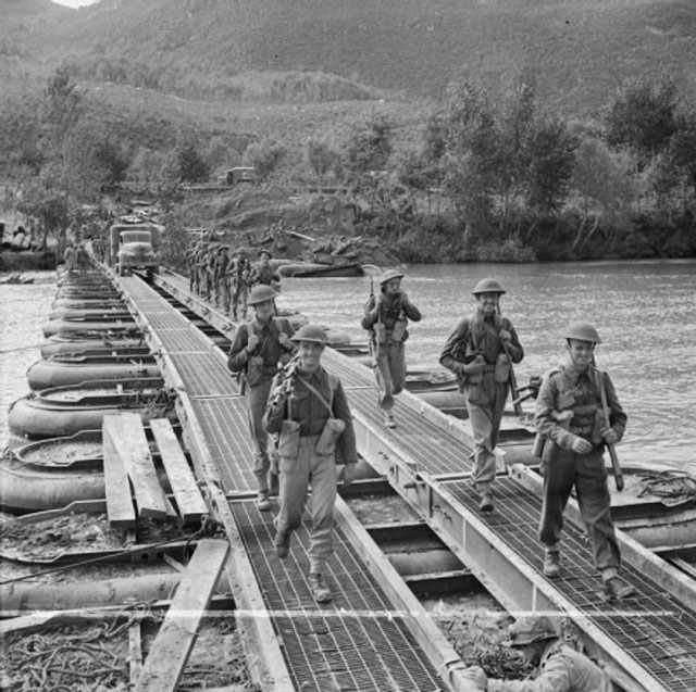 Troops crossing a pontoon bridge