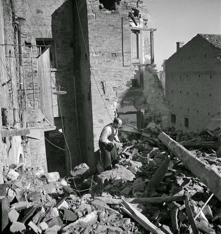 Italian Civilian Searches Ruins of his Home