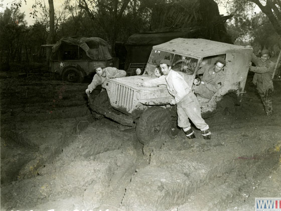 Pushing a Jeep out of Mud