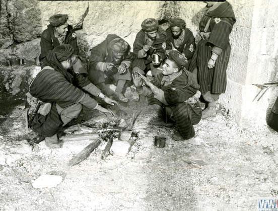 Moroccan troops gathered around a small fire