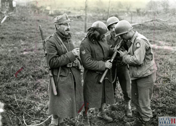 US soldier examines Italian machine gun