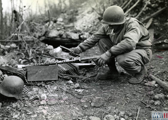 US soldier examines German machine gun