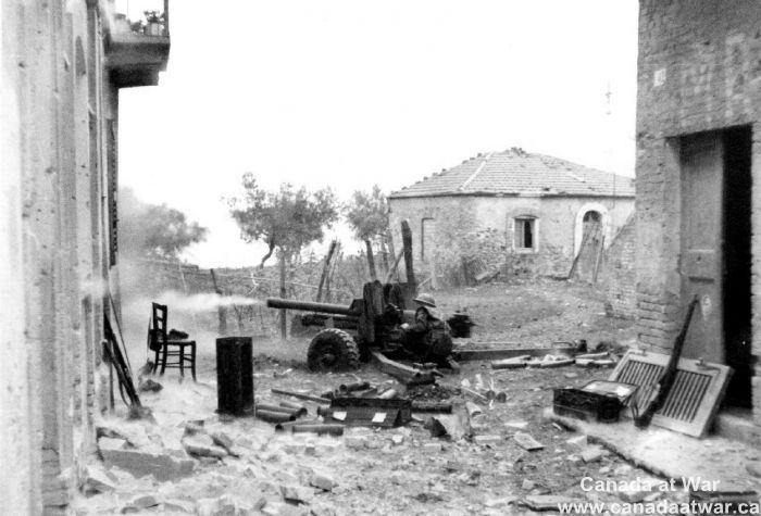 Soldier firing 6-pounder anti-tank gun