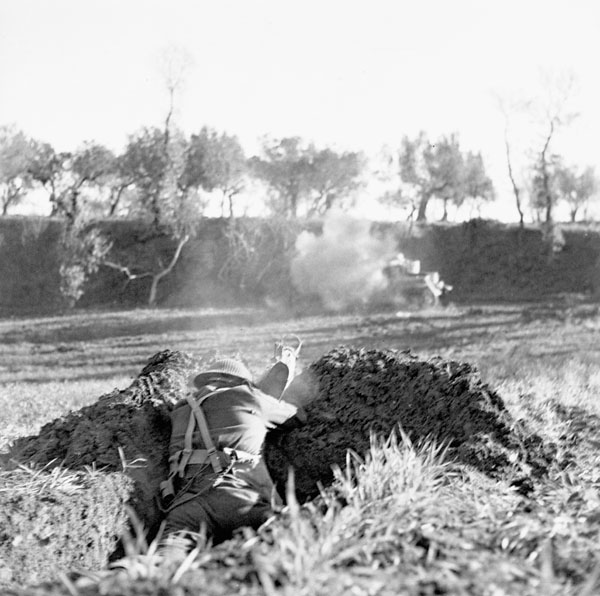 firing a PIAT anti-tank weapon