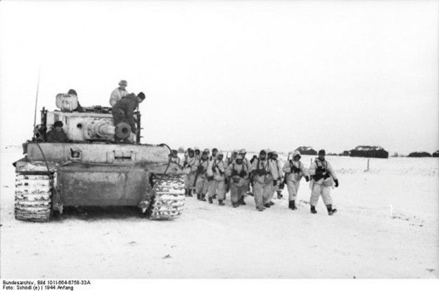 German Troops March Past a Tiger Tank