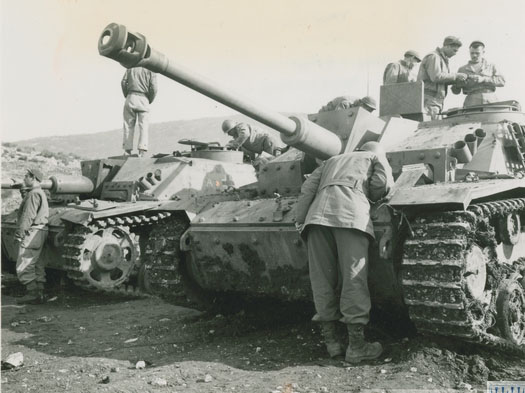 Soldiers examining tank