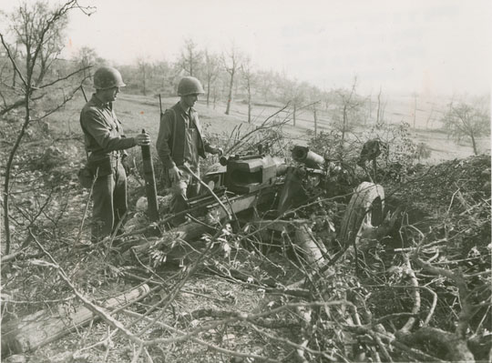 Soldiers Examining a Weapon