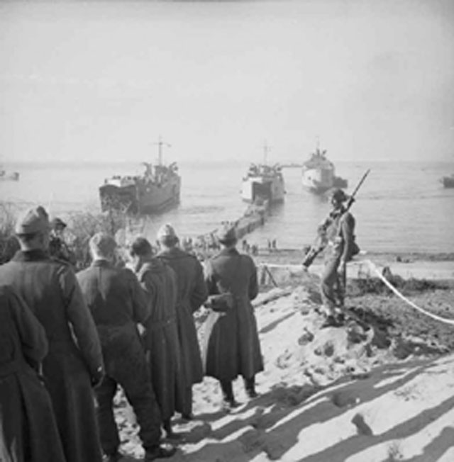 German Prisoners Watch Allied Troops Disembark