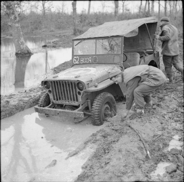 The crew of a jeep attempt to dig out