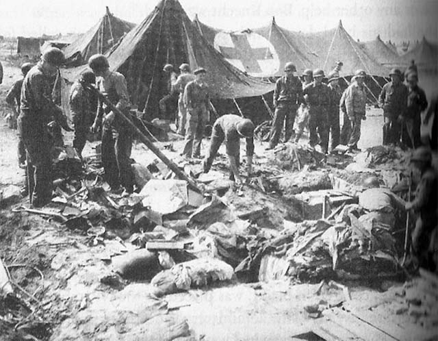 Personnel contemplating the bomb damage