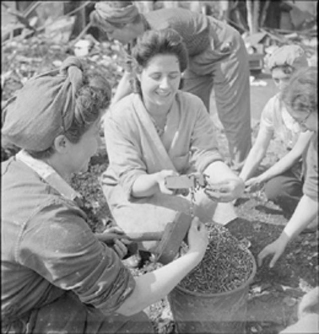 Women war workers use magnets