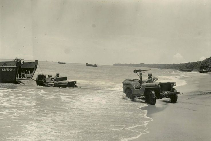 A Jeep Towing Another Jeep out of the Water