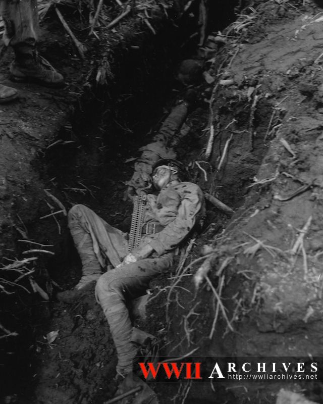 A Dead Japanese Soldier Lies in a Trench