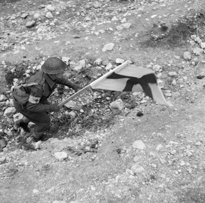 Medic Moving Forward Under Cover of Red Cross Flag