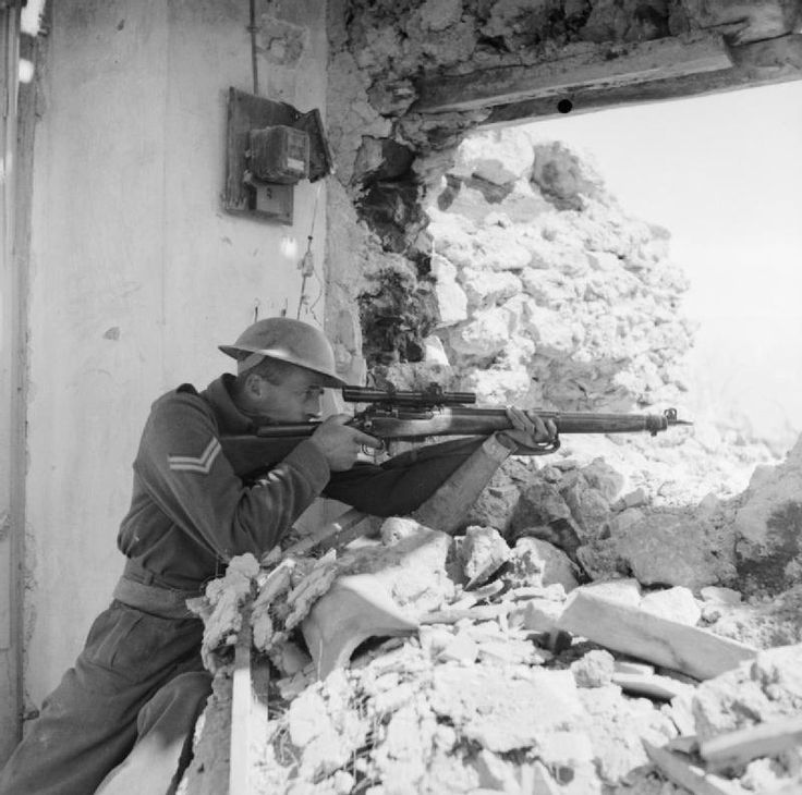 A New Zealander Poses with his Sniper Rifle