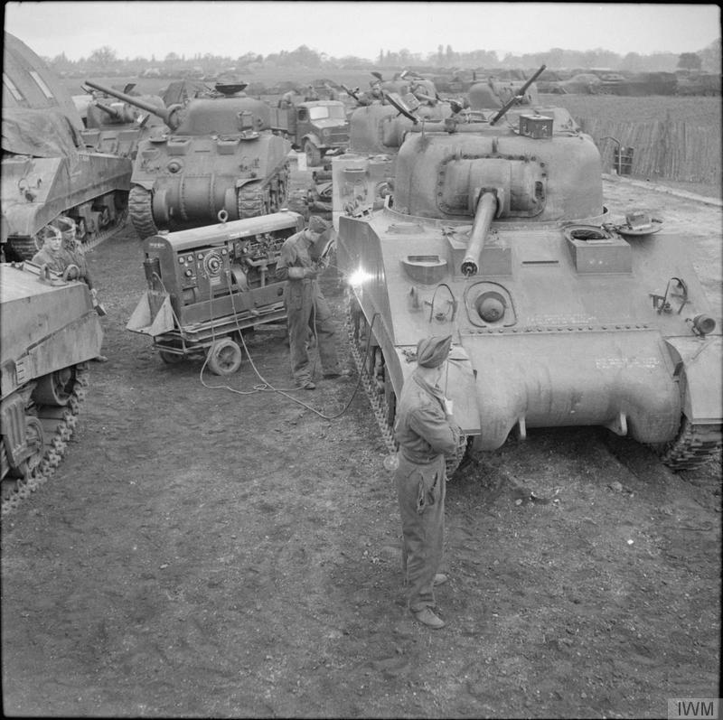 Sherman tanks being maintained