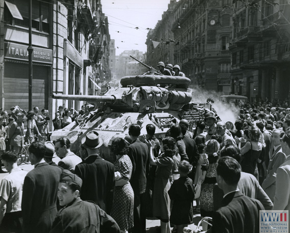 Waves of cheers greet the appearance of Allied tanks