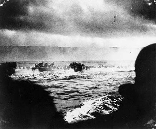 convoy of landing craft nears the beach