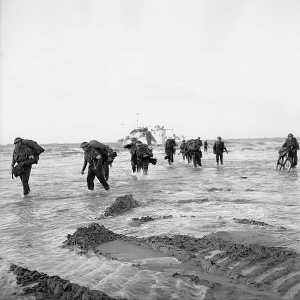 Follow-up troops wade ashore