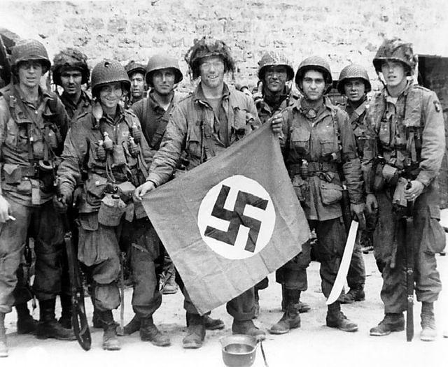 Holding a Captured Nazi Flag