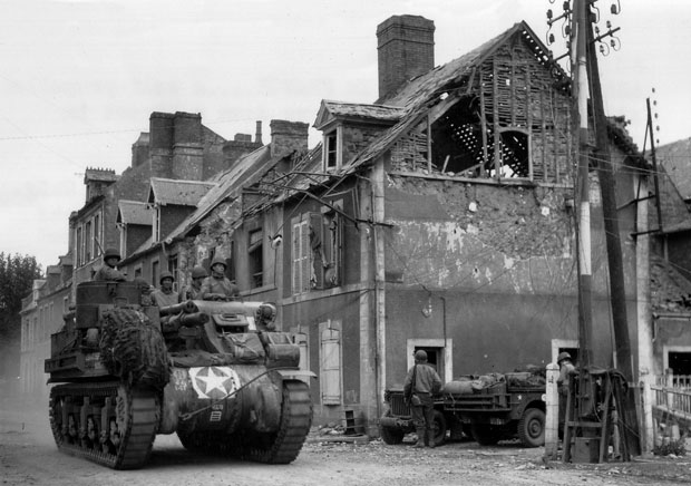 US Army M7 Priest Tank Transits through Carentan