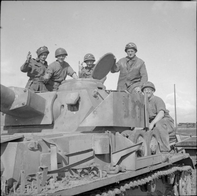 Crew of a Sherman Pose with German Tank