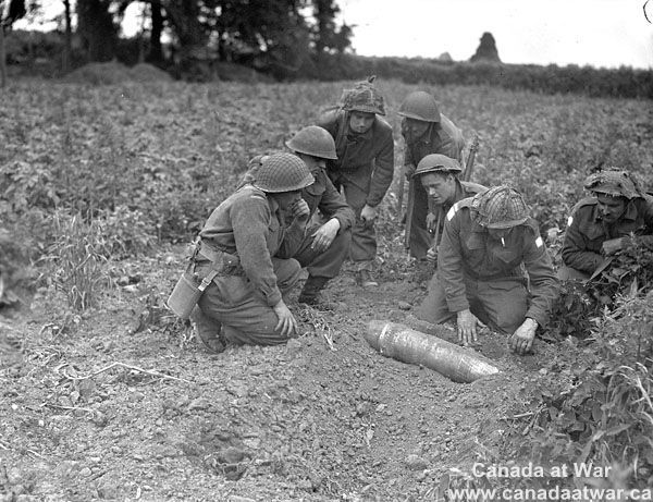 Unidentified Sappers Examining Unexploded Shell