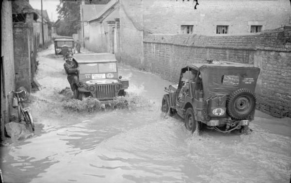 Jeeps in a Flooded Village