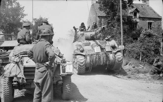 Sherman Firefly passes a scout car