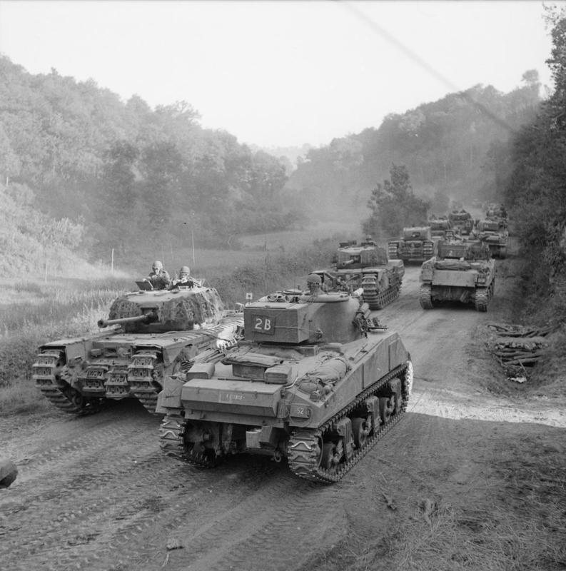 Sherman Tanks Pass a Column of Churchills