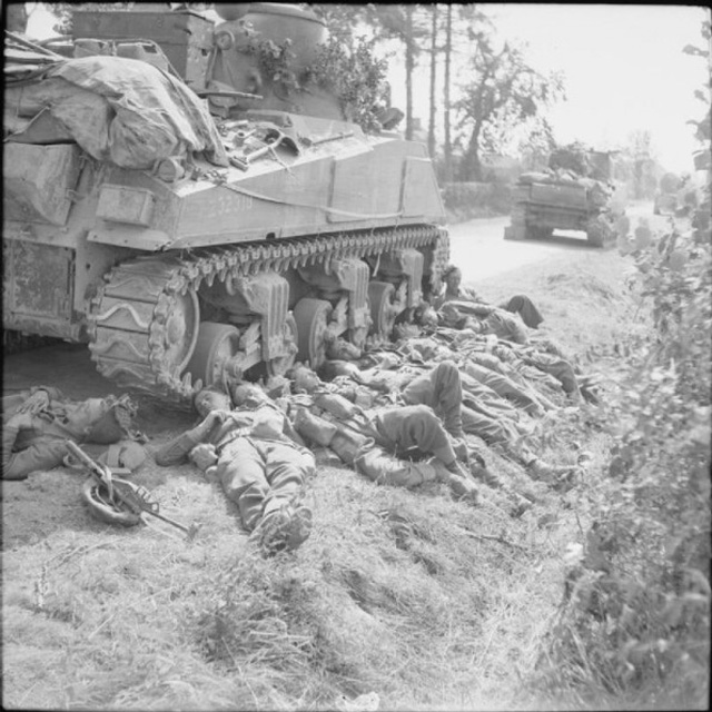 resting next to a Sherman tank