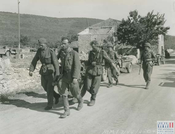 German POWs Carry a Wounded Fellow Soldier