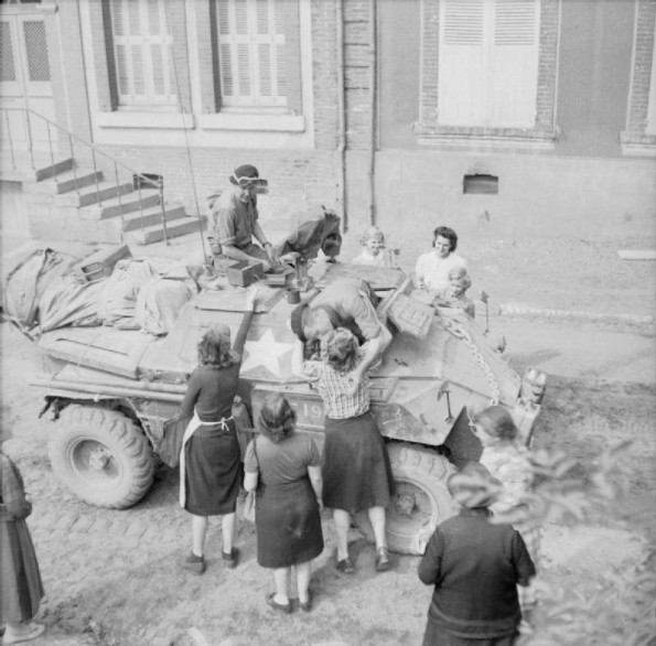 Scout car crew are greeted