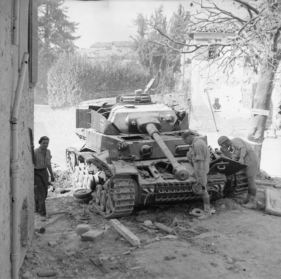 Troops Examining a Wrecked Tank