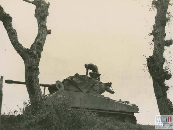 US serviceman on top of a Sherman tank