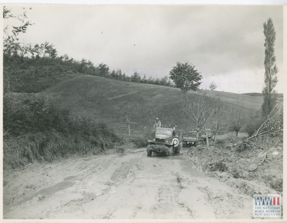 US army truck trying to drive through muddy road