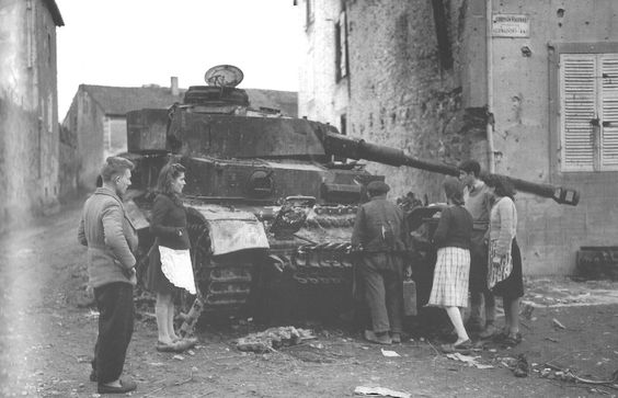 Surveying a Burnt Out <i>Pz.Kpfw.IV Ausf.J</i>