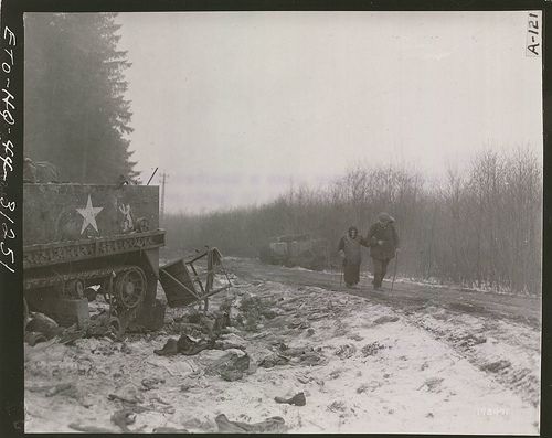 Refugees Pass Disabled American Vehicle