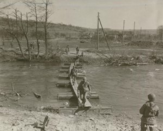 US Army Patrol Crosses a Footbridge