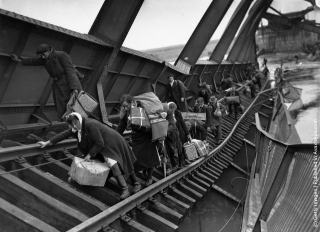 Displaced Persons Crossing a Bridge